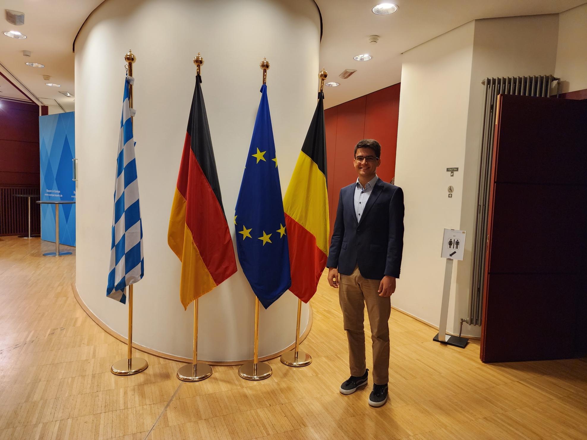 Milan Ferus-Comelo in front of flags
